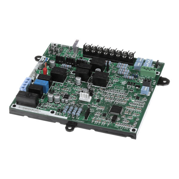 A green printed circuit board with various electronic components, including capacitors, resistors, relays, and connectors, mounted on its surface.