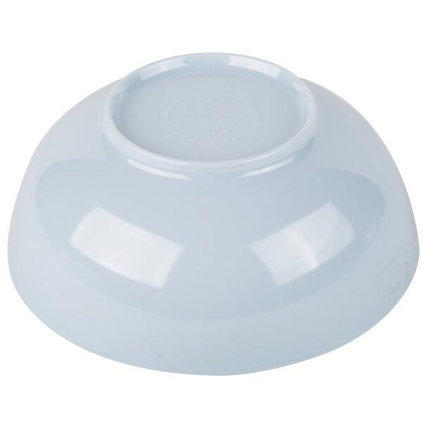 A white bowl with a round blue lid.