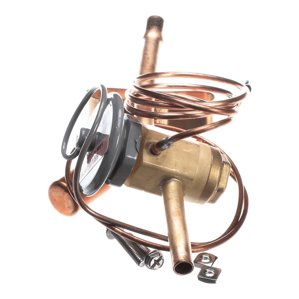 A brass valve assembly with attached copper tubing, a round dial, and two screws with washers, photographed on a white background.