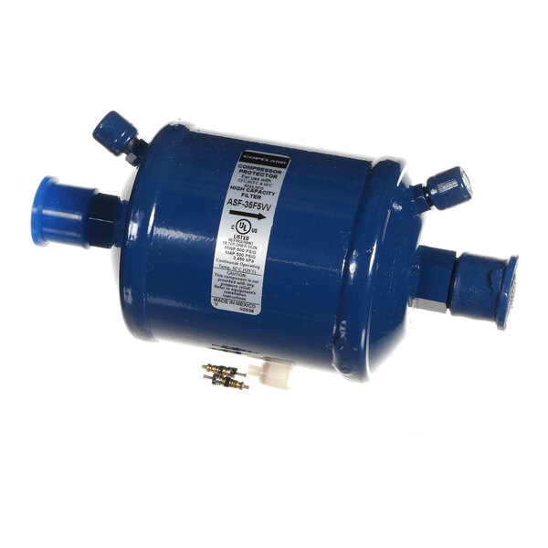 A cylindrical blue metal component with multiple pipe connections and a label on its side.