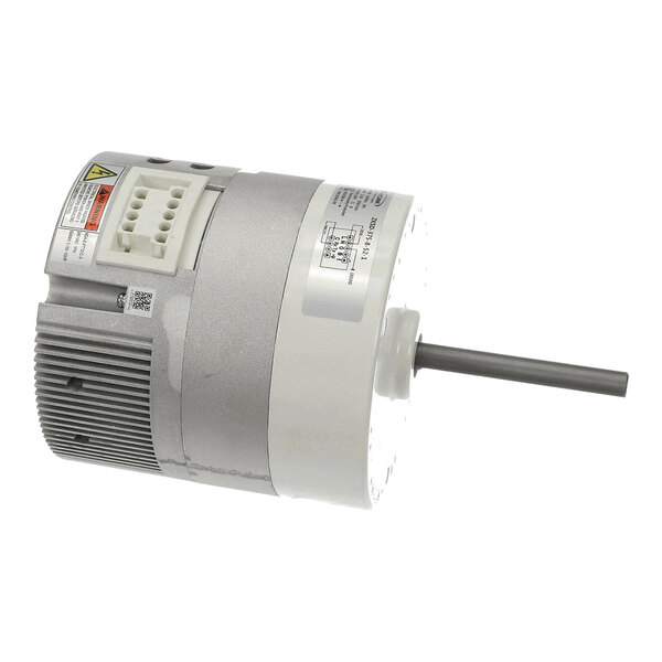 A cylindrical electric motor with a protruding shaft and a vented housing, featuring a white terminal block and warning labels on its surface.
