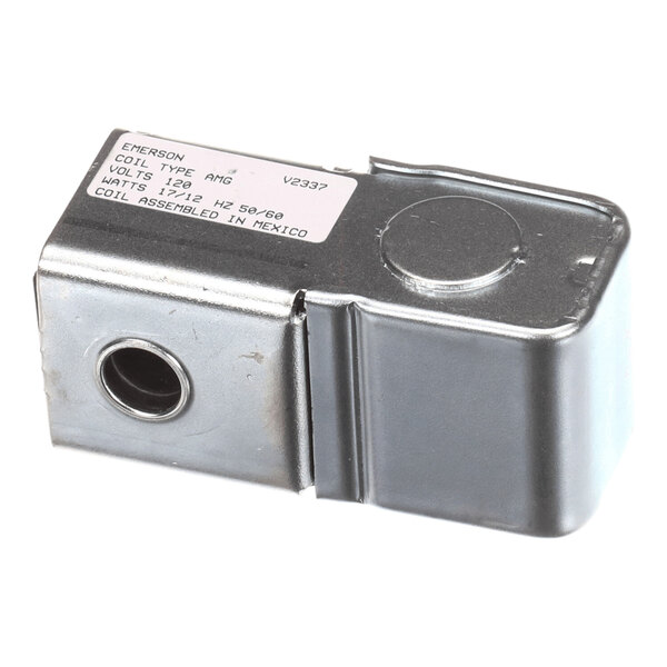 A rectangular metallic component with a circular opening on one side and a label on top displaying technical specifications.
