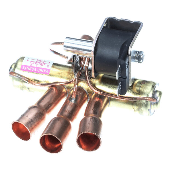 A metal valve assembly with multiple copper pipe connections and an attached black plastic component.
