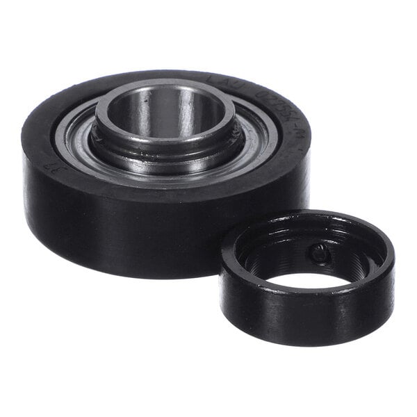 A black circular bearing with a separate matching ring placed beside it, both featuring metallic inner components.