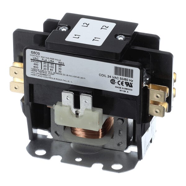 A two-pole electrical contactor with visible copper coil, labeled terminals, and a specification label on the side.