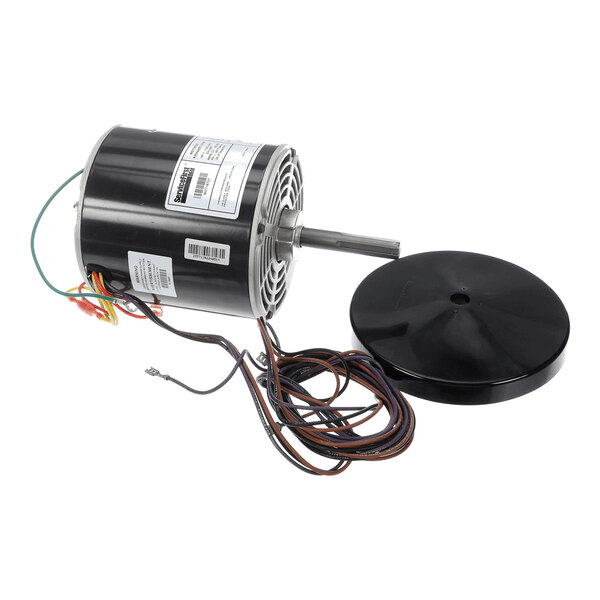 A cylindrical electric motor with attached wires and a separate round black cover placed beside it.