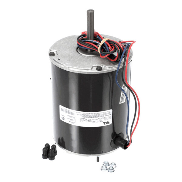 A cylindrical electric motor with a metal shaft, attached wires, and small hardware components placed beside it.