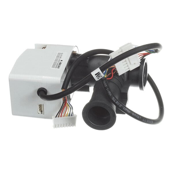 A black plastic valve assembly with attached wiring and connectors, alongside a white rectangular component.