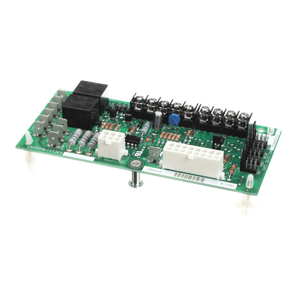 A green electronic control circuit board with various connectors, relays, and components mounted on it.