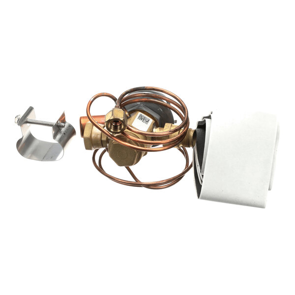 A brass valve assembly with coiled copper tubing, a metal clamp, and a white insulated component.