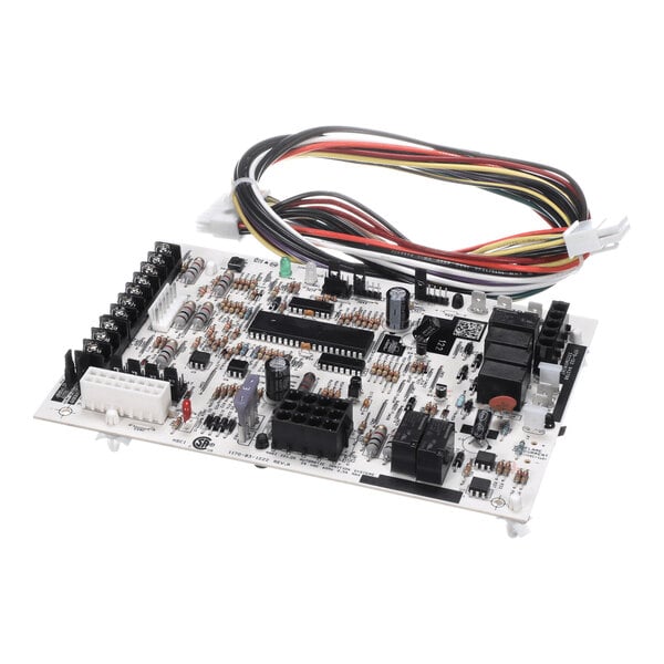 A white electronic circuit board with various components and a bundle of multicolored wires attached.