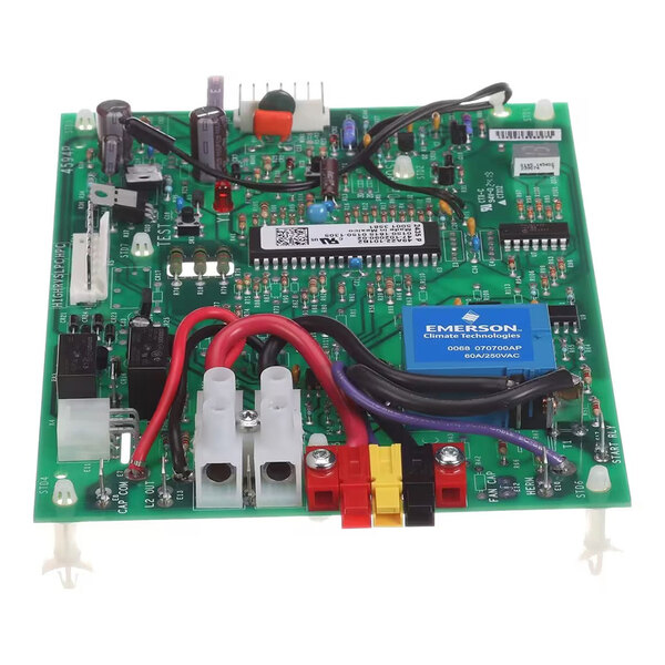 A green electronic circuit board with various components, connectors, and colored wires attached.