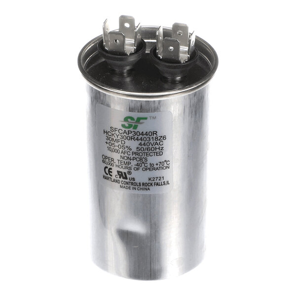 A cylindrical metal capacitor with two sets of electrical terminals on top and a label displaying technical specifications.
