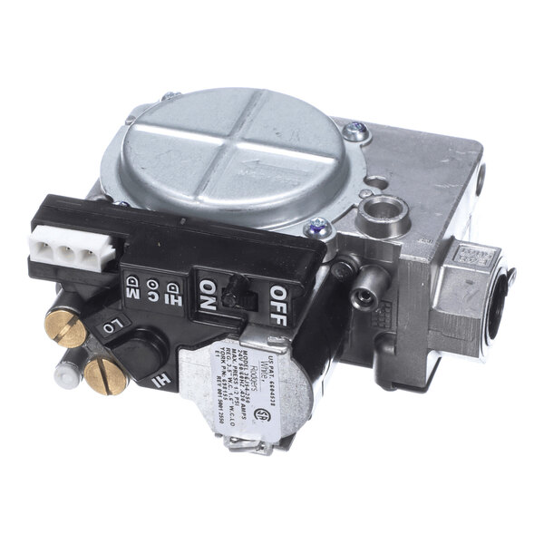 A metallic gas valve assembly with control switches, adjustment knobs, and electrical connectors visible.