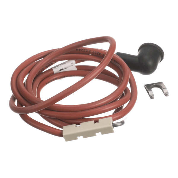 A coiled red wire with a black rubber end, a white connector, and a small metal clip placed beside it.