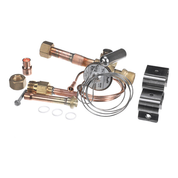 A set of metal components including copper tubes, brass fittings, a coiled wire, and mounting brackets, arranged on a white background.