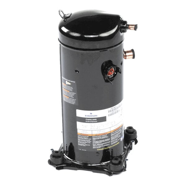 A black cylindrical metal component with copper pipe fittings and a label, mounted on a base with four feet.