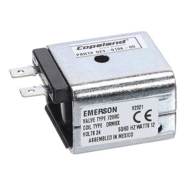 A rectangular metallic solenoid coil with two electrical terminals and product labels indicating specifications and manufacturer details.