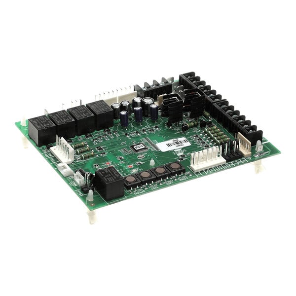 A green electronic circuit board with various components including capacitors, relays, connectors, and heat sinks mounted on it.