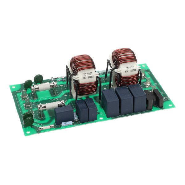 A green printed circuit board featuring multiple electronic components, including two large copper coil inductors, blue rectangular relays, cylindrical resistors, and various other components.