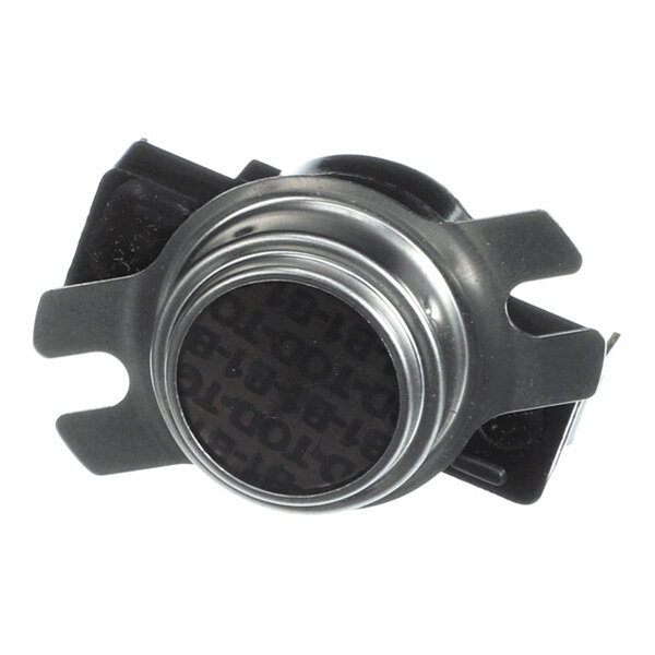 A metal and plastic component with a circular center and two protruding tabs on each side, likely an electronic or mechanical part.
