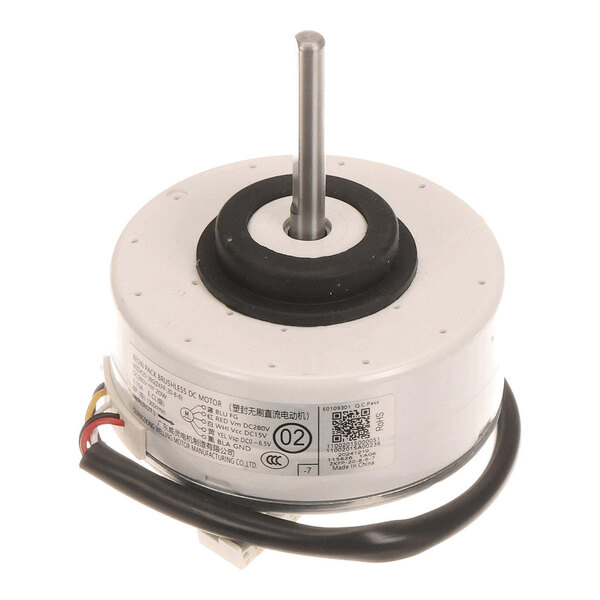 A cylindrical electric motor with a central metal shaft, attached wires, and a label with technical specifications.