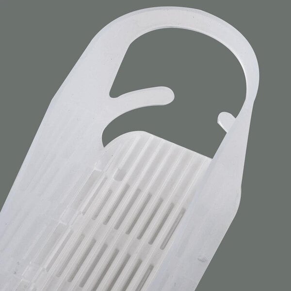 A close-up of a white plastic Trueflex bottle organizer with holes.