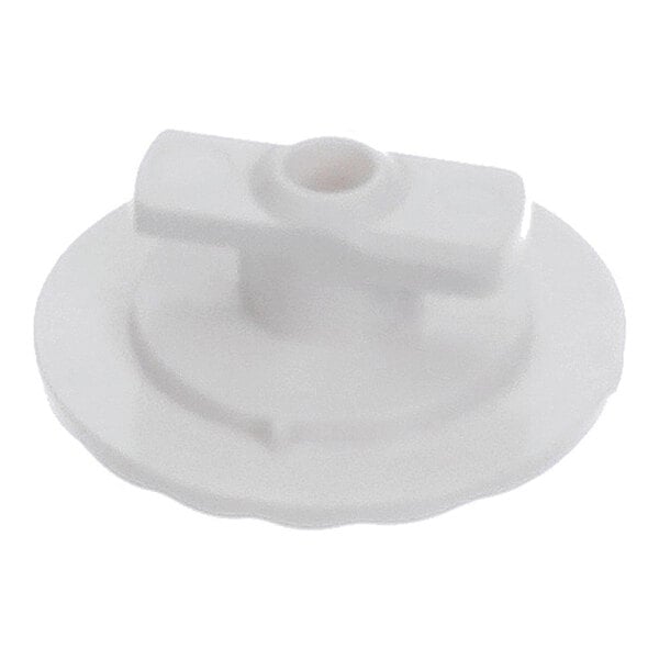A white, round plastic component with a central raised section and a horizontal bar across the top.