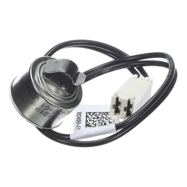 A small metallic cylindrical component with an attached black wire and a white plastic connector.