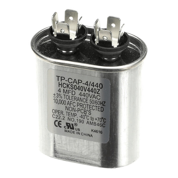A metallic oval capacitor with two terminal posts and a label displaying technical specifications.