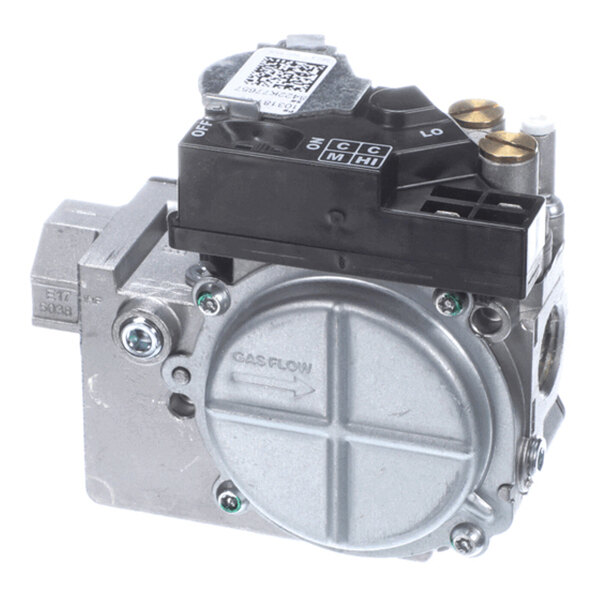 A metallic gas valve with a round cover, labeled 'GAS FLOW,' and a black plastic control module on top with various settings and brass fittings.