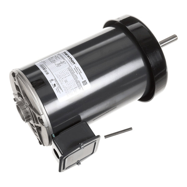 A cylindrical electric motor with a metallic finish, a protruding shaft, and an attached electrical box, shown with a small metal rod beside it.