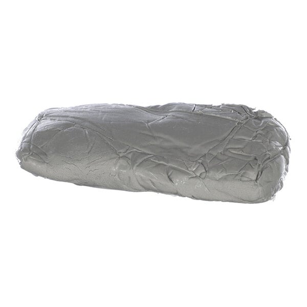 A gray, rectangular, and slightly flattened lump of pliable material with a smooth and wrinkled surface.
