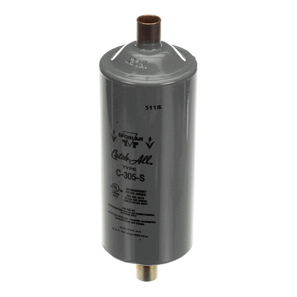 A cylindrical gray metal filter-drier with copper pipe connections on both ends and printed labeling on the side.