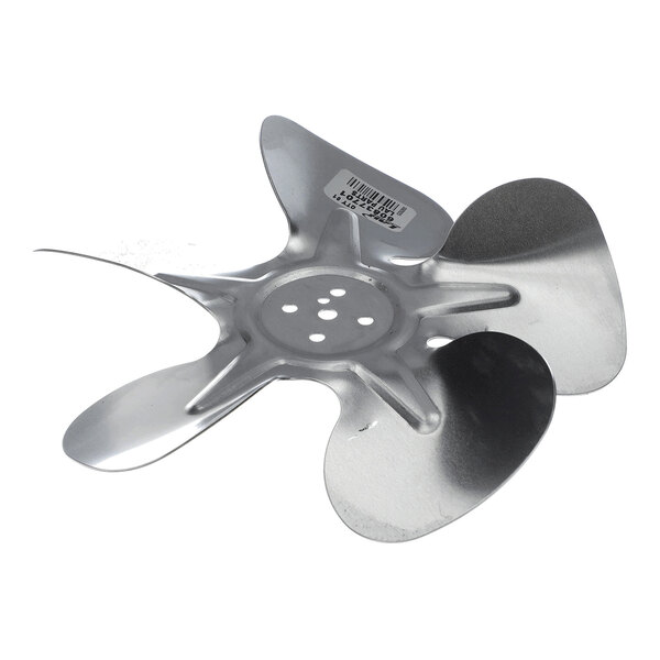 A four-blade metallic fan propeller with a central hub featuring multiple holes and a barcode sticker on one blade.