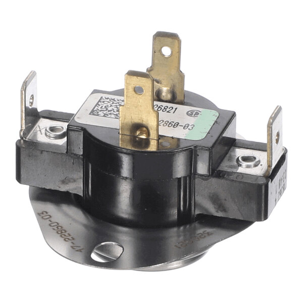 A close-up view of a black and metallic electrical component with four flat metal terminals and a round mounting base.
