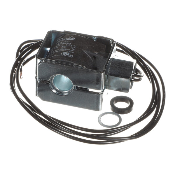 A black rectangular electrical coil with attached wires and two circular washers placed beside it.