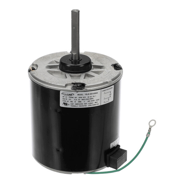 A cylindrical electric motor with a metal shaft protruding from the top and a green grounding wire attached to the side.