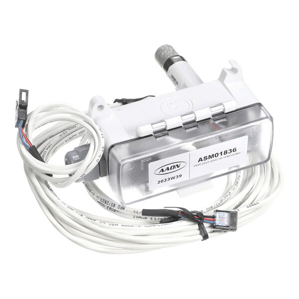 A white electronic sensor device with a clear cover, labeled 'ASM01836,' attached to long white cables with connectors.