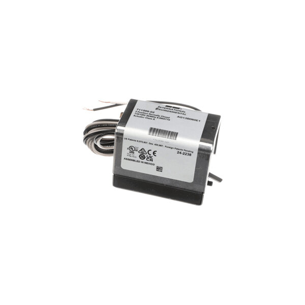A small electrical device with a metal casing, attached wires, and a label displaying technical information and certification symbols.