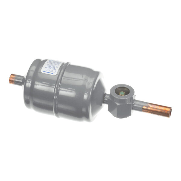 A cylindrical metallic component with copper pipe fittings on both ends and an integrated sight glass on one side.