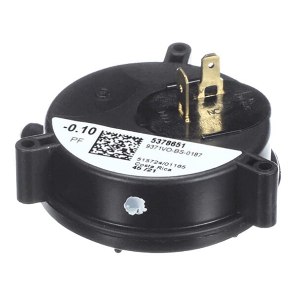 A round black component with a white label, featuring two brass electrical terminals and mounting flanges.