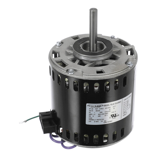 A cylindrical electric motor with a central shaft, ventilation slots, and an attached label displaying specifications.