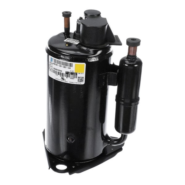 A black cylindrical metal component with attached pipes and a label, likely part of a mechanical or HVAC system.