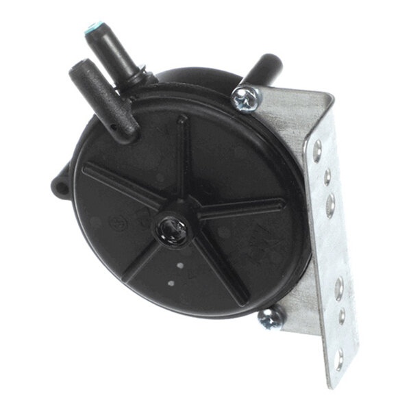 A round black plastic component with two protruding nozzles, mounted on a metal bracket with screws.