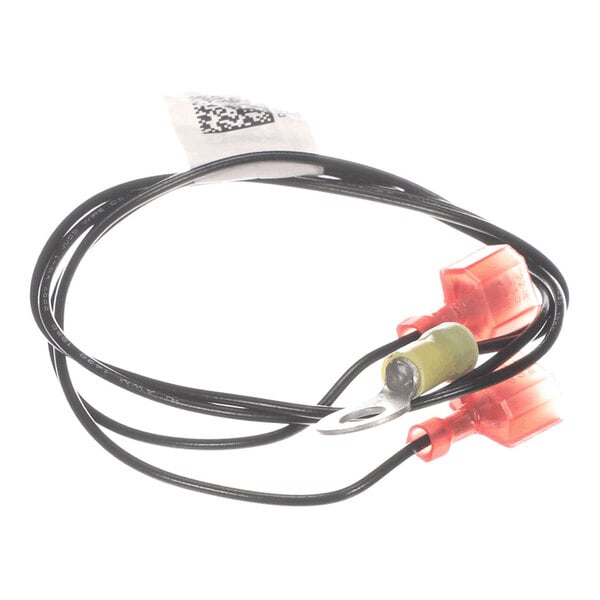 A coiled black wire with red connectors and a metal ring terminal, along with a small label attached.