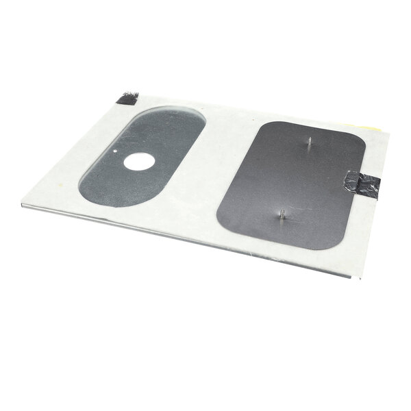 A rectangular sheet with two cut-out sections, one oval with a circular hole and one rectangular, both covered with dark material and secured by tape.