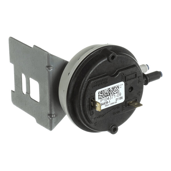 A round black and silver pressure switch with a metal mounting bracket and two electrical terminals, featuring a label with product information.