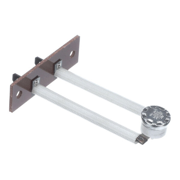 A metal solenoid valve assembly with a cylindrical actuator and copper pipe connections, shown next to a rectangular metal control box with labeled indicators.