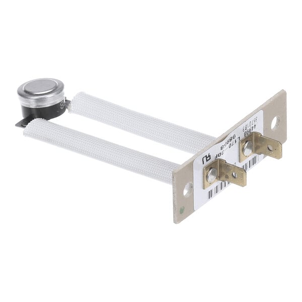 A metal component with two white insulated rods, a round metallic sensor on one end, and two brass electrical terminals mounted on a flat metal plate with labels.